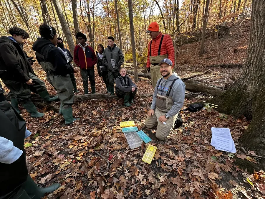 Students exploring outdoors under autumn trees